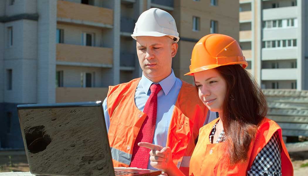 Occupational Safety Professional using laptop on project site