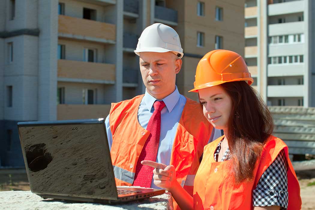 Occupational Safety Professional using laptop on project site
