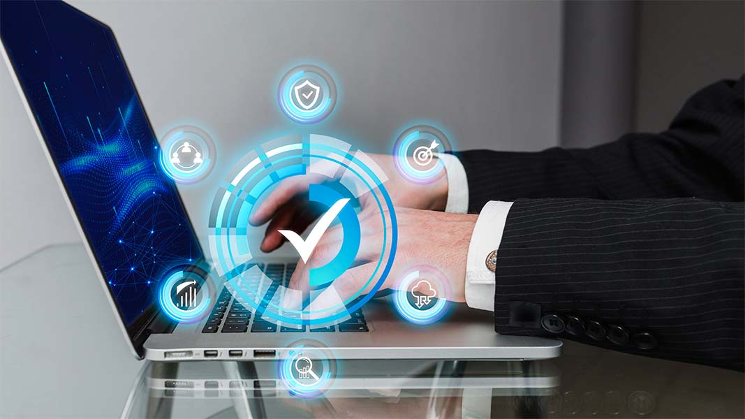 A laptop and symbol of ISO 9001 digital transformation