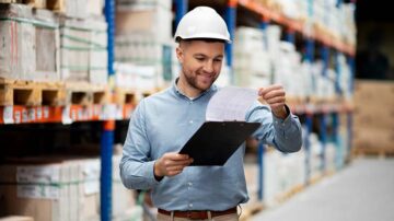 ISO 9001 Lead Auditor is checking the details on a paper