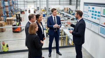 Professionals reviewing quality management processes in an industrial facility, demonstrating the Requirements of ISO 9001 Certification in UAE through performance monitoring and operational control.